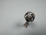 a close up of a silver object on a white surface