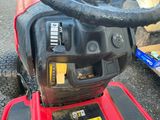 a close up of the steering of a red lawn mower