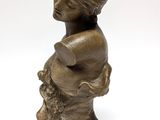 statue of a woman with a basket of flowers in her hands