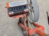 a small wheel with a meter on it sitting on the ground