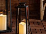 two candles that are sitting on a wooden table