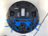 a black and blue robot with blue brushes on it