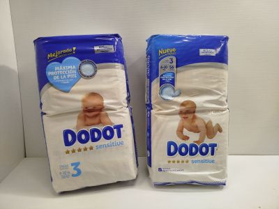 two packs of baby diapers sitting on top of a white counter