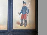 four framed pictures of men in uniforms of different ages and sizes