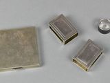 three small silver boxes sitting next to each other on a table