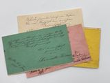 three envelopes with handwritten letters on them sitting on a table