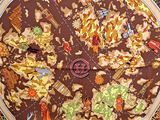 a large pizza on a table with many different toppings