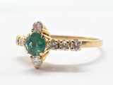 an image of a close up of a ring with a green stone