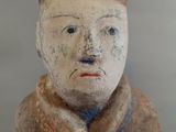 a clay figurine of a man sitting on a table