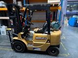 a forklift that is parked in a warehouse