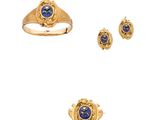 three gold rings and a ring with a lapis stone in the center