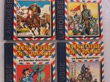 quatre livres pour enfants sont alignés sur une surface blanche