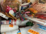 a cardboard box filled with many different types of crafting supplies