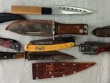 many different types of knives on a table