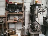 a machine that is sitting in a garage next to a shelf
