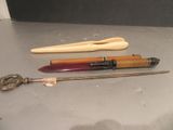 trois stylos différents et une brosse à dents posés sur une table