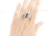 a woman ' s hand with a ring on it