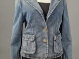 a woman ' s denim jacket with buttons and buttons on the front