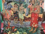 a man standing next to a large painting of people