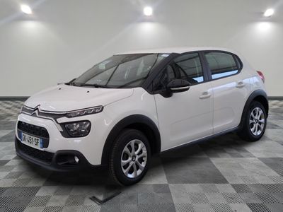 the white citrole is parked on a checkered tile floor