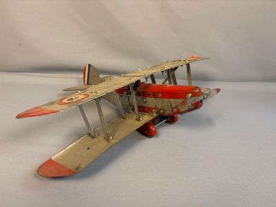 a toy airplane that is sitting on a white surface