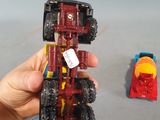 a hand holding a toy truck with a red car on it