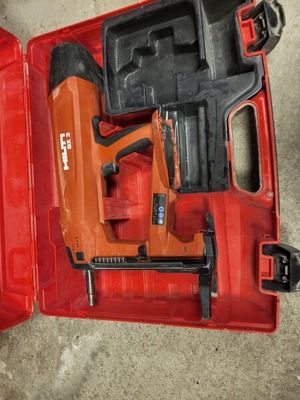 a red tool box with a stapler and a stapler in it
