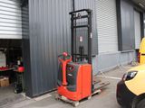 a fork lift truck parked in front of a building