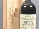 a bottle of wine sitting next to a wooden box