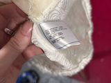 a person holding a white hat with a label on it
