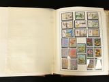 an open book with stamps on it sitting on a table