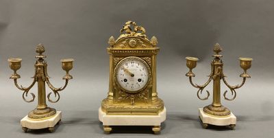three different types of clocks on display on a table