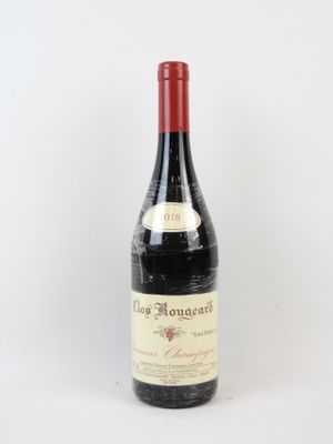 une vieille bouteille de vin posée sur une table blanche