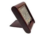 a clock that is sitting on a stand on a white background