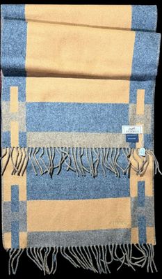 blue and yellow checkered wool scarf with fringes on a black background