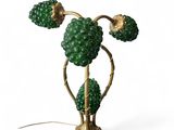 a close up of a green lamp on a white surface