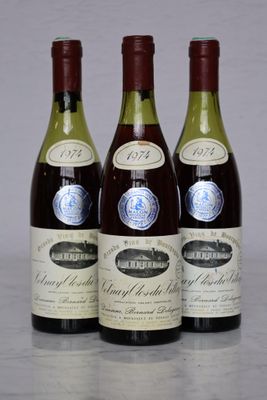 three bottles of wine are lined up on a table