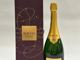 une bouteille de champagne à côté d'un carton de vin