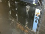 a dirty kitchen with a metal counter and a microwave