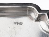 a silver tray that has a handle on it