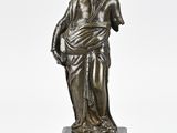 an image of a bronze statue of a man holding a bag