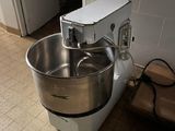 a mixer that is sitting on the floor in the kitchen