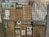 a large metal cage with boxes on top of it