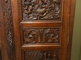 an old wooden cabinet with carvings on it in a room