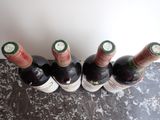 several bottles of wine are lined up in a row on a table