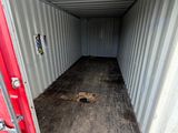 a red door in the middle of a white container