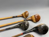 several different types of golf clubs are lined up on a table
