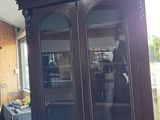 a large wooden cabinet in the middle of a room