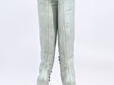 pair of women ' s white leather boots with spikes on the heel