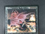 a picture of a card with a picture of a demon on it